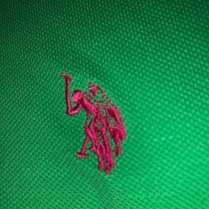 very cropped green polo shirt with pink detailing